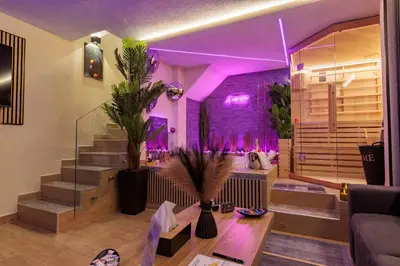 a living room with purple lighting and a staircase at A' Casuzza Suite Room in Porticello