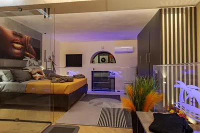a living room with a bed and a table at A' Casuzza Suite Room in Porticello