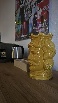a gold vase sitting on top of a table at Isula SeaView Apartments in Isola delle Femmine