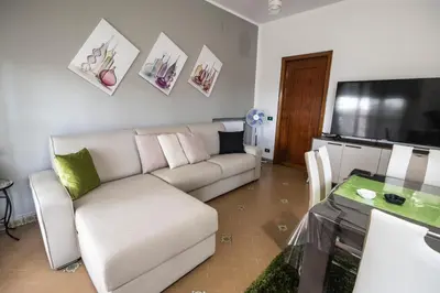 a living room with a couch and a table at Sicily Wonders, 2 minute walk to the beach in Villagrazia