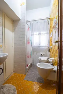 a bathroom with a toilet and a sink at Sicily Wonders, 2 minute walk to the beach in Villagrazia