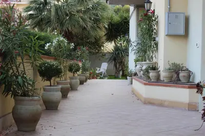 a walkway with potted plants on the side of a building at Casa Chiarenza in Castellammare del Golfo