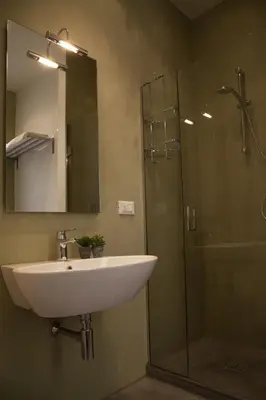 a bathroom with a sink and a glass shower at Rosalmar B&B in Palermo