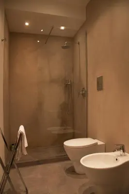 a bathroom with a shower and a toilet and a sink at Rosalmar B&B in Palermo