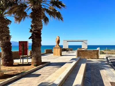 a path with palm trees and the ocean in the background at Apartment Terrazza sul Mare by Interhome in Balestrate