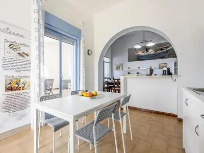 a kitchen and dining room with a white table and chairs at Apartment Terrazza sul Mare by Interhome in Balestrate