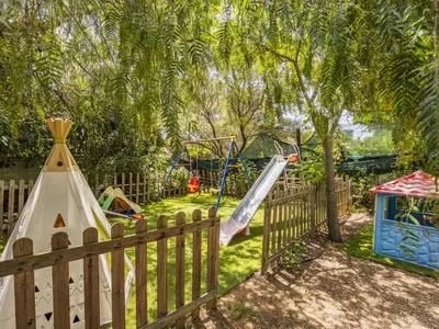 a playground with a slide and a swing set at Apartment Cicladi Naxos by Interhome in Santa Flavia