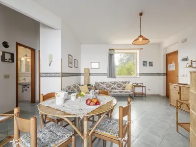a living room with a table and chairs at Apartment Cicladi Naxos by Interhome in Santa Flavia