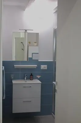 a bathroom with a sink and a mirror at Bom Bom Apartments in Castellammare del Golfo