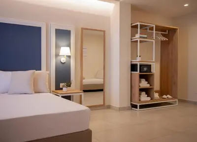a bedroom with a white bed and a mirror at Balestrate Center Rooms in Balestrate