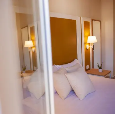 a bedroom with a bed with white pillows at Balestrate Center Rooms in Balestrate
