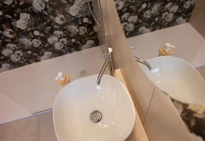 a bathroom with a white toilet and a sink at Balestrate Center Rooms in Balestrate
