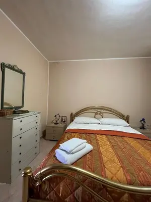 a bedroom with a bed with a dresser and a mirror at Casa Marina in Isola delle Femmine