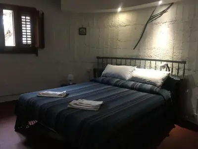 a bedroom with a bed with two towels on it at Holiday Green in Carini