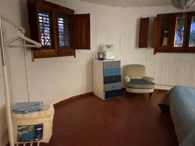 a room with a dresser and a chair in a room at Holiday Green in Carini