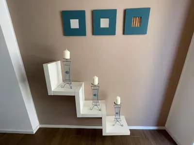 a room with two white candles on a wall at Appartanvilla Magellano in Mondello