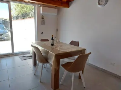 a dining room with a table with wine bottles and chairs at Casa Asprigna in Ficarazzi