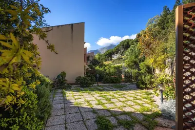 a white hammock hanging from an orange tree at Torre delle mandre in Altavilla Milicia