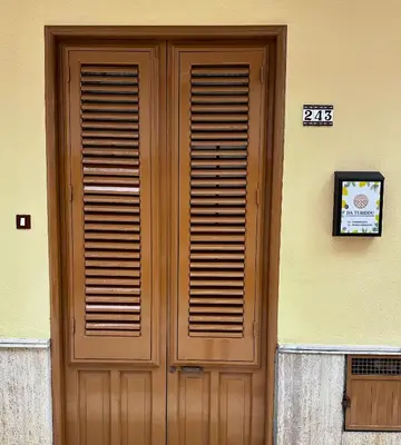 a wooden door on the side of a building at Da Turiddu in Cinisi