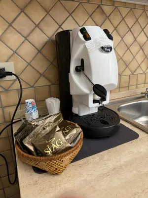 a sewing machine sitting on a counter next to a sink at Da Turiddu in Cinisi