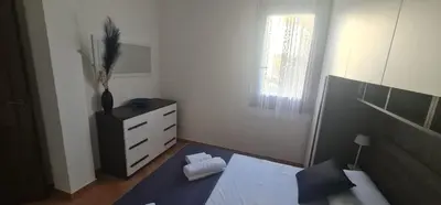 a bedroom with a bed and a dresser and a window at I Giardini del mare casa vacanza in Buonfornello