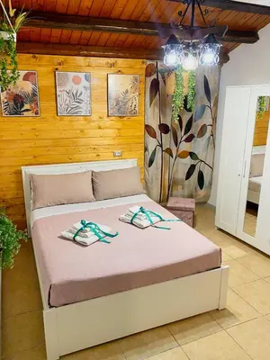 a bedroom with a large bed in a room at La Casetta di Dandrì in Monreale