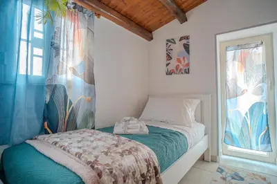 a small bedroom with a bed and a window at La Casetta di Dandrì in Monreale