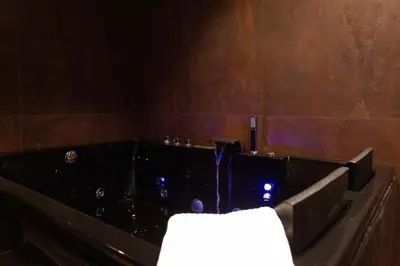 a bath tub with a fountain in a room at Black Room Suite and SPA in Carini