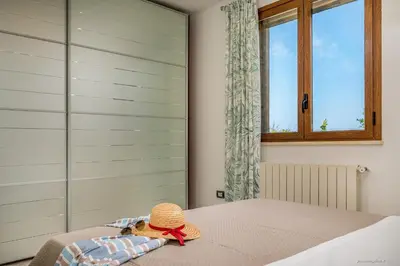 a hat sitting on top of a bed with a window at Oasi delle Nereidi in Alcamo