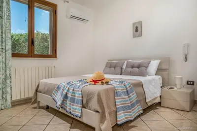 a bedroom with a bed with a hat on a table at Oasi delle Nereidi in Alcamo