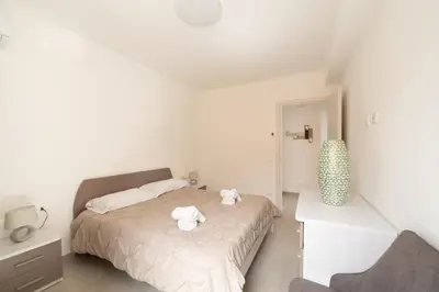 a bedroom with a bed with two towels on it at Villa Soho in Castellammare del Golfo