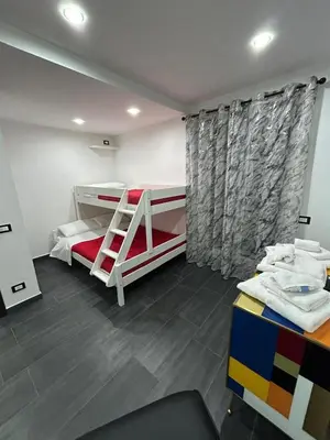 a bedroom with two bunk beds and a window at Maisondedesign in Palermo