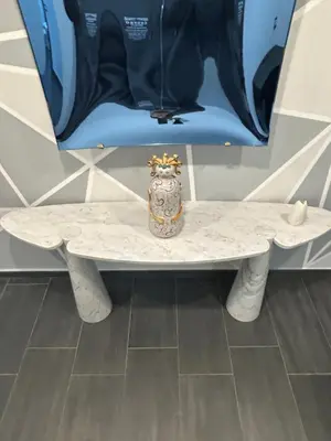 a white table with a vase sitting on top of it at Maisondedesign in Palermo