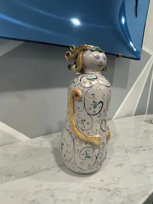 a vase with a handle on a table at Maisondedesign in Palermo