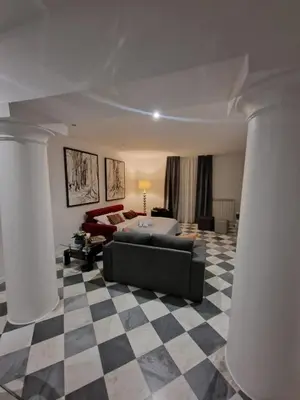 a living room with a couch and a checkered floor at Colonne San Domenico in Palermo