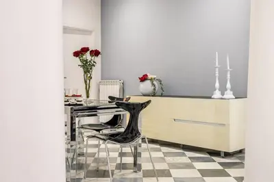 a kitchen with a counter and a table with chairs at Colonne San Domenico in Palermo