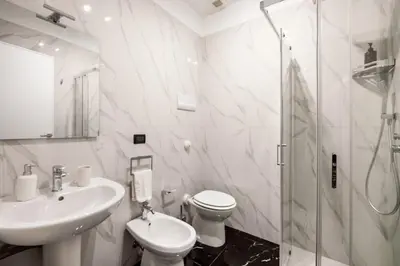 a bathroom with a sink and a toilet and a shower at Colonne San Domenico in Palermo