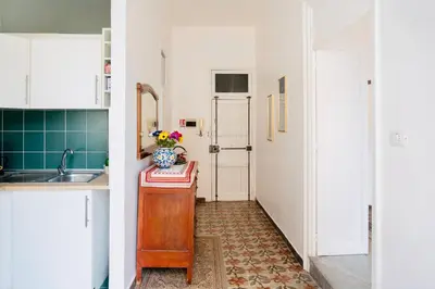 a kitchen with a sink and a table with a vase on it at Piano Imperiale Home in Palermo