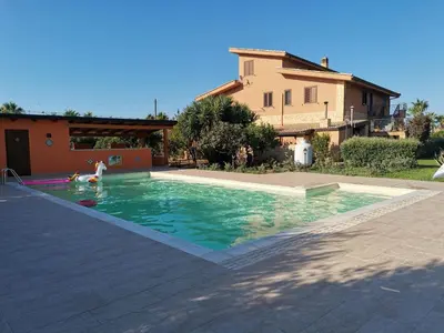 a person playing in a swimming pool in a house at Borgomare in Campofelice di Roccella