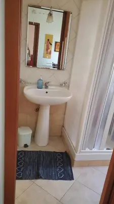 a bathroom with a sink and a mirror at Al Politeama casa vacanze in Palermo