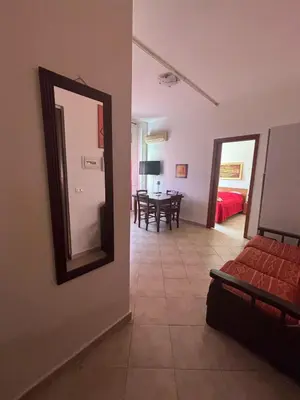 a bedroom with a mirror and a dining room at Al Politeama casa vacanze in Palermo