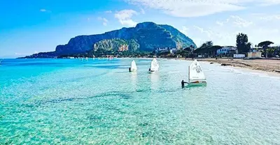 three small sailboats in the water on a beach at Al Politeama casa vacanze in Palermo