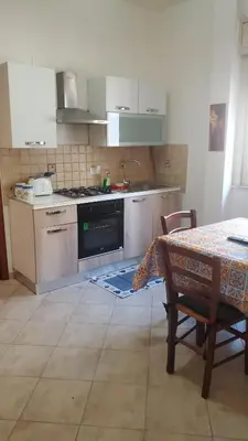 a kitchen with a table and a sink and a stove at Al Politeama casa vacanze in Palermo