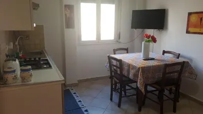 a kitchen with a table with a vase of flowers on it at Al Politeama casa vacanze in Palermo