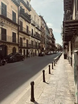 a street with cars parked on the side of the road at Manuè's House in Palermo