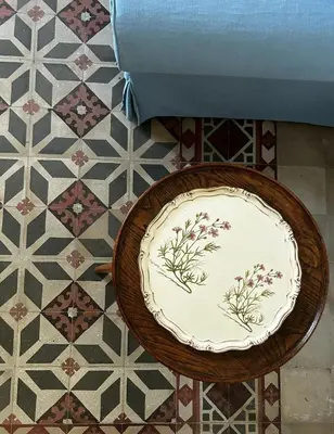 a plate on top of a table on a tiled floor at Casa Mediterraneo in Palermo