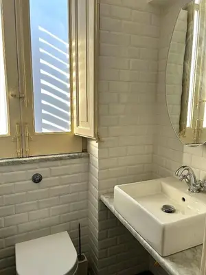 a bathroom with a sink and a toilet and a mirror at Casa Mediterraneo in Palermo