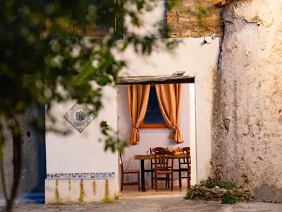 an entrance to a house with a table and a curtain at Rooms Parrinelli in Partinico