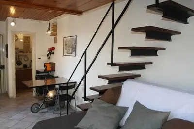 a living room with stairs and a couch and a table at Targa Moto Art in Palermo