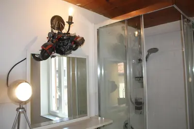 a bathroom with a shower and a mirror and a lamp at Targa Moto Art in Palermo